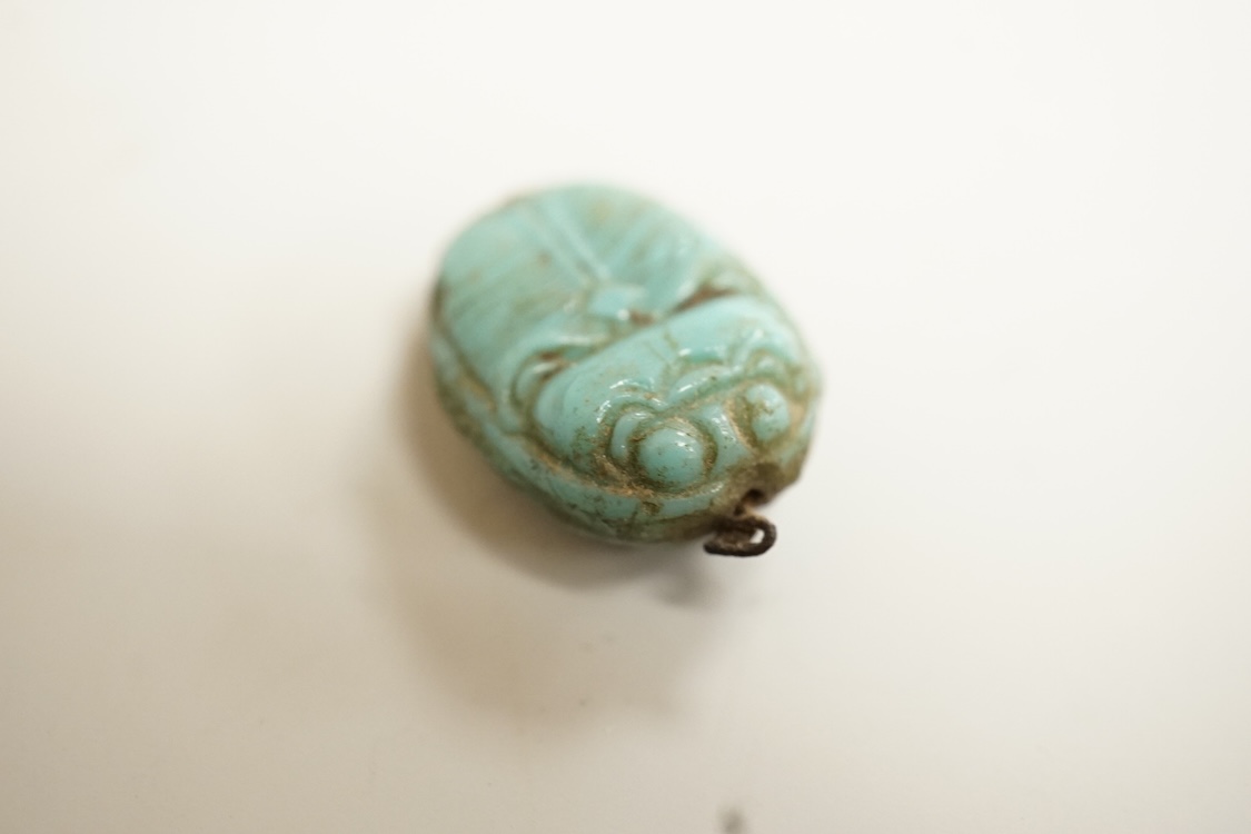 A Chinese carved rock crystal lion, a turquoise bead and a small quantity of marbles, lion 8.5cm wide